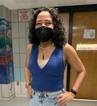 a girl wearing a face mask in a hallway